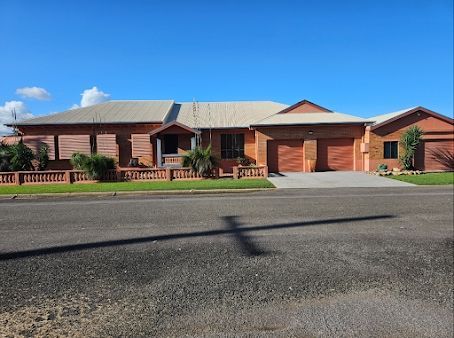 A Large Brick House Sits on the Side of the Road — DJ's Pressure Cleaning In Carruchan, QLD