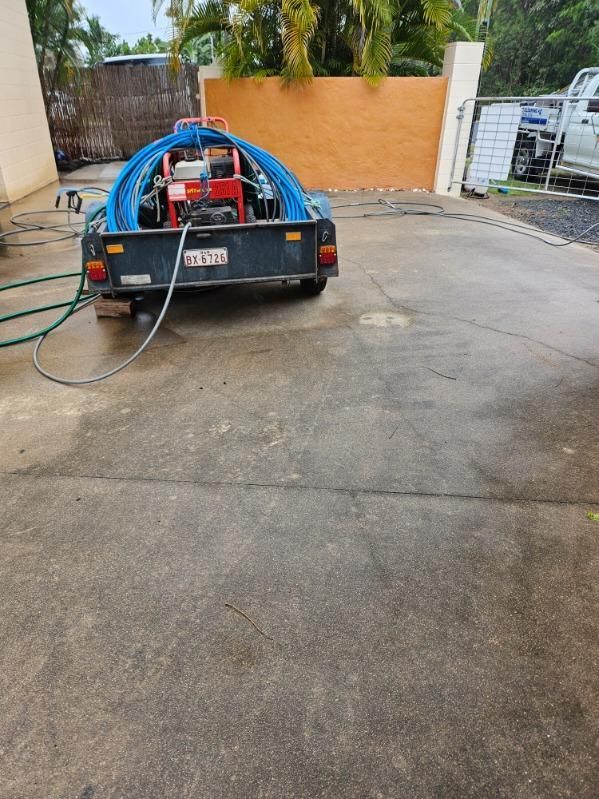 A Trailer With a Hose Attached to It is Parked in a Parking Lot — DJ's Pressure Cleaning In Carruchan, QLD
