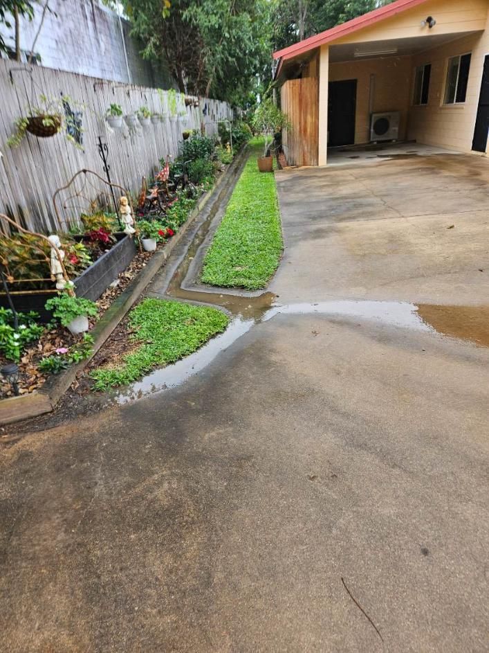 A House With a Driveway and a Garden in Front of It — DJ's Pressure Cleaning In Mission Beach, QLD