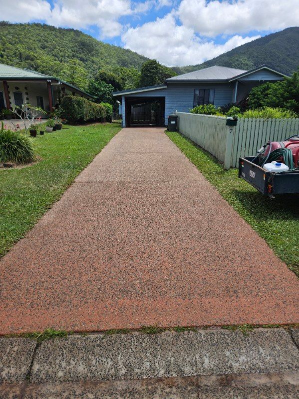 A Driveway Leading to a House With a Truck Parked on the Side of It — DJ's Pressure Cleaning In Carruchan, QLD