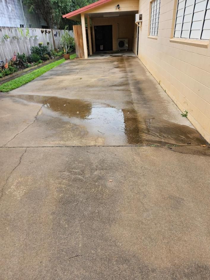 A Concrete Driveway Leading to a House With a Red Roof — DJ's Pressure Cleaning In Ingham, QLD