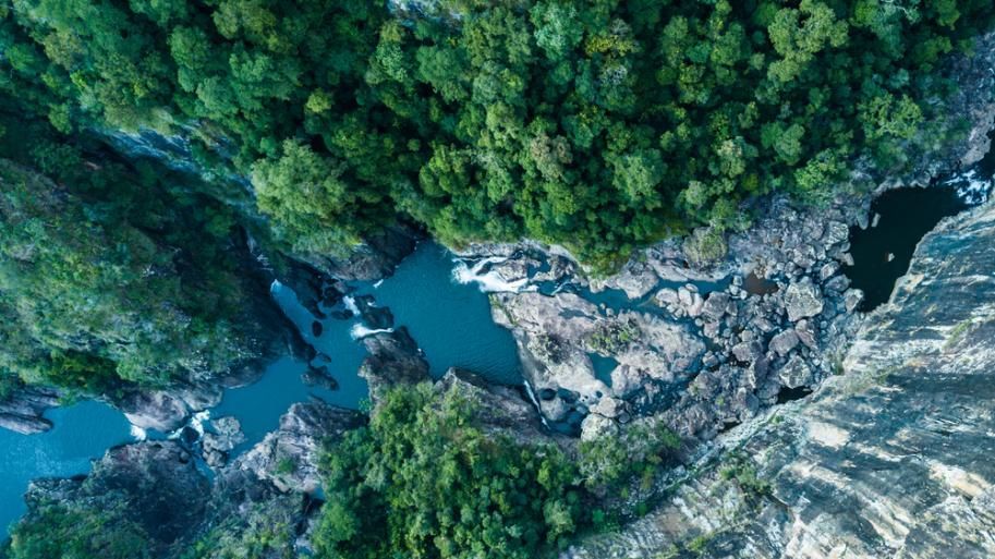 An Aerial View of a Waterfall in the Middle of a Forest — DJ's Pressure Cleaning In Ingham, QLD
