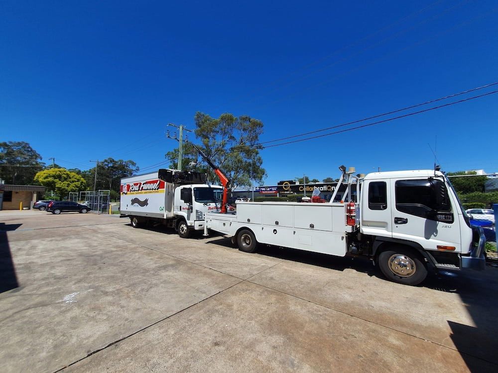 Two Tow Trucks Are Parked Next To Each Other In A Parking Lot  — Newcastle Truck Repairs in Newcastle, NSW