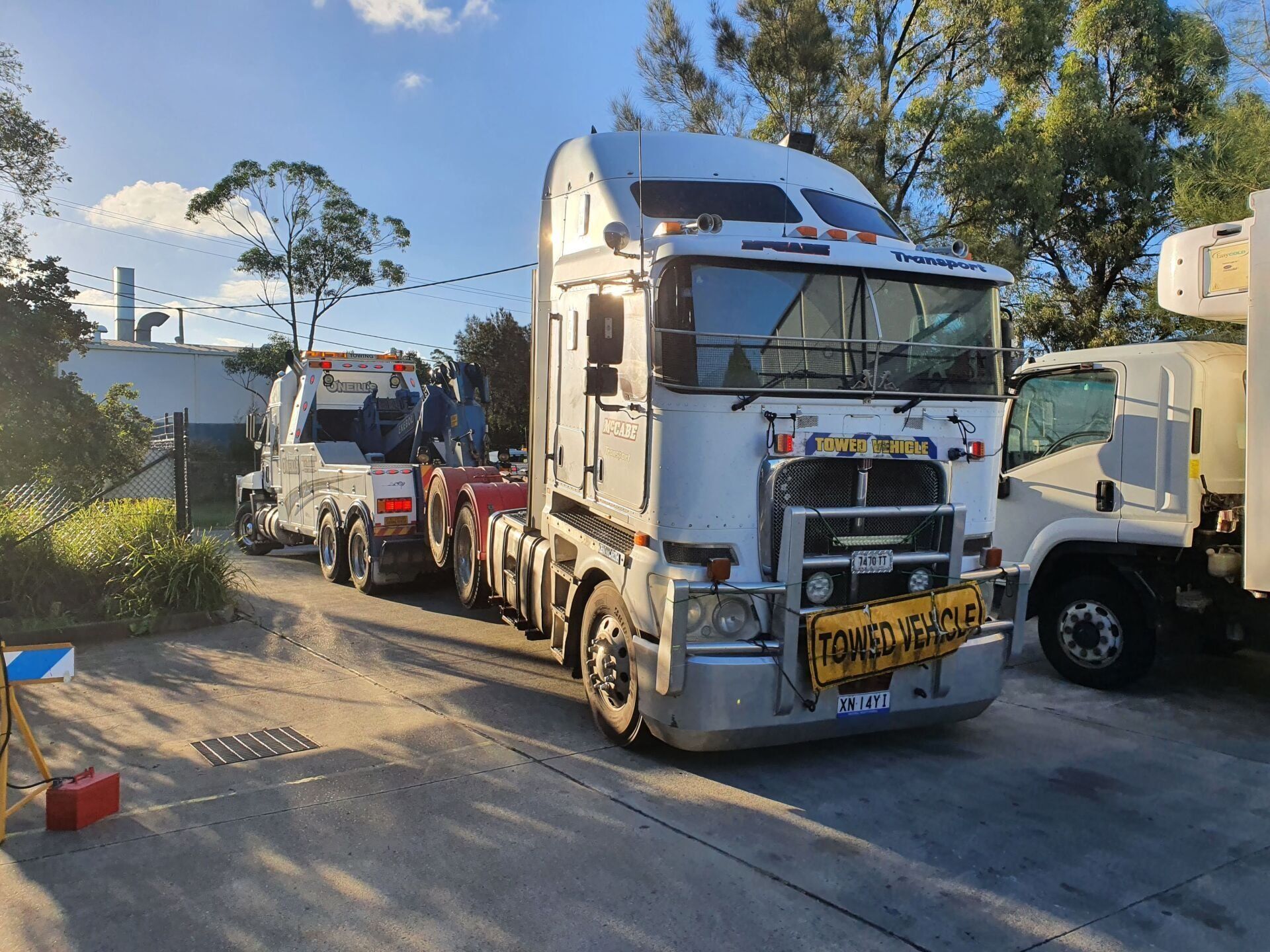 A Man Is Working On A Truck Engine With A Wrench — Newcastle Truck Repairs in Thornton, NSW