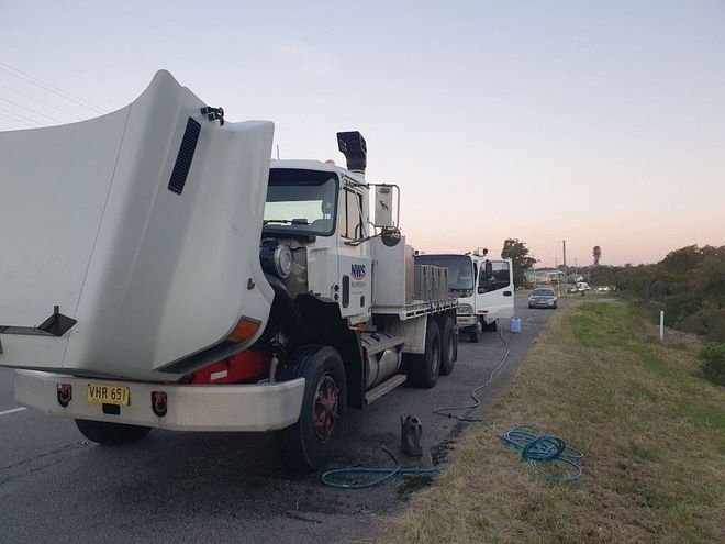 Truck with open hood on the side of the road; other vehicles are parked behind — Newcastle Truck Repairs in Thornton, NSW