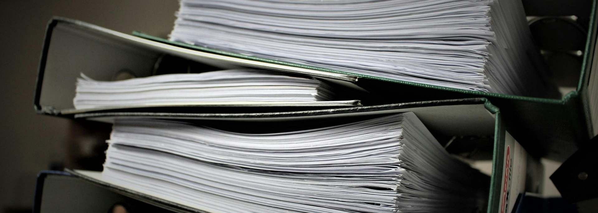 Picture of paper folders piled on top of each other. 