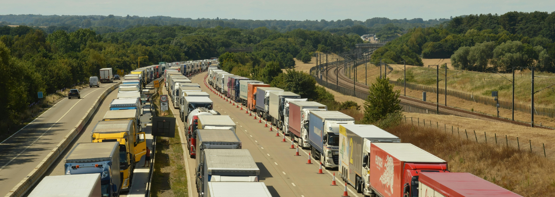 Picture of a line of trucks, no moving traffic. 
