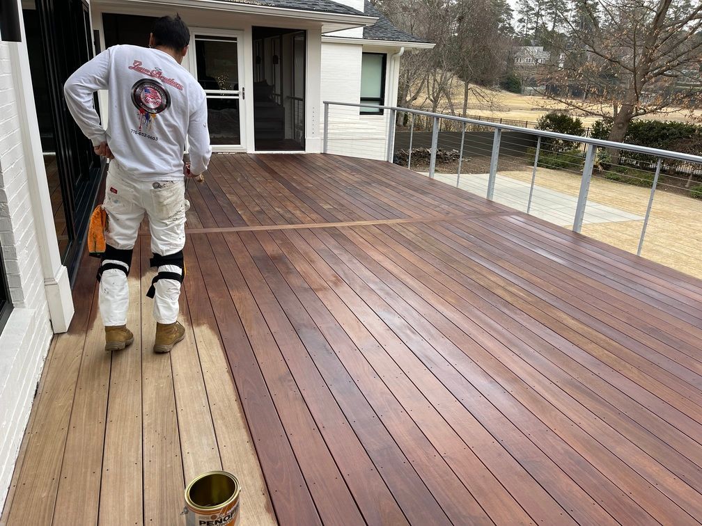 A man is walking on a wooden deck.