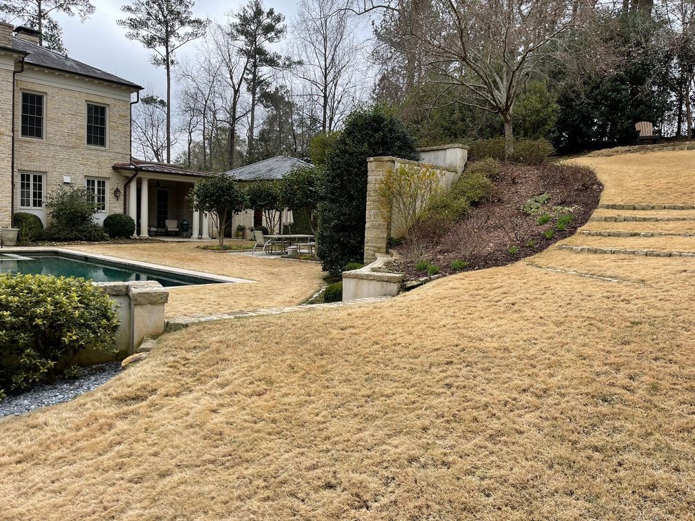 There is a large house with a pool in the backyard.