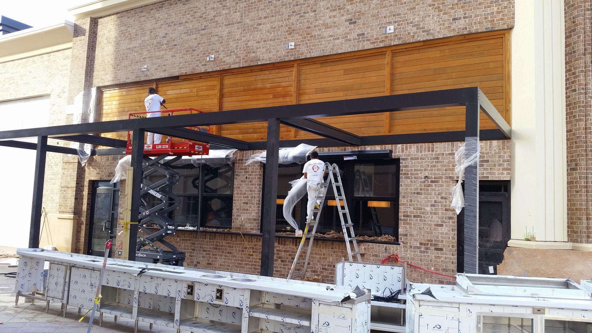 A group of people are working on the side of a building.