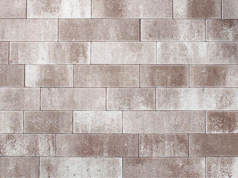 Eine Nahaufnahme einer braunen und weißen Ziegelmauer