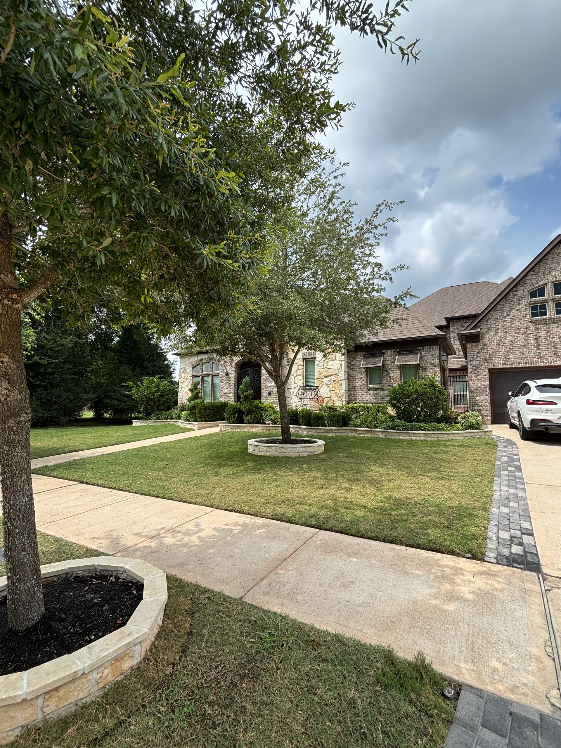 A brick building with a gravel walkway leading to it.