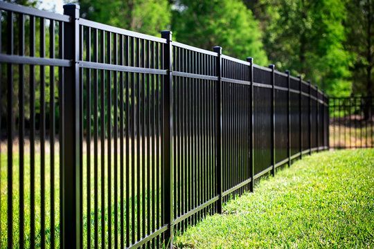 A green fence with the word peavler written on it