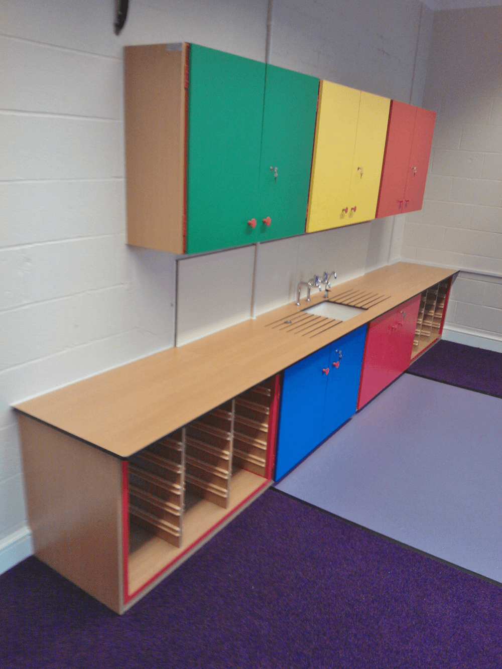 coloured storage units and sink