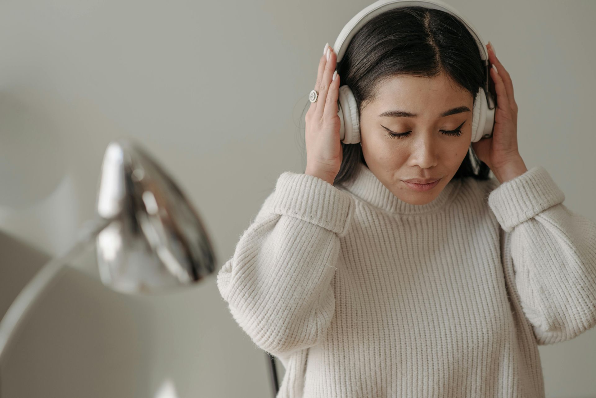 A woman wearing headphones is listening to music.