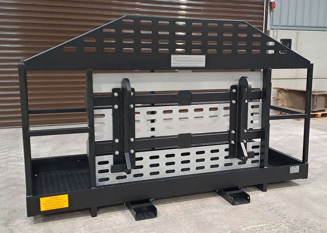 A black and white metal structure is sitting on the ground in front of a building.