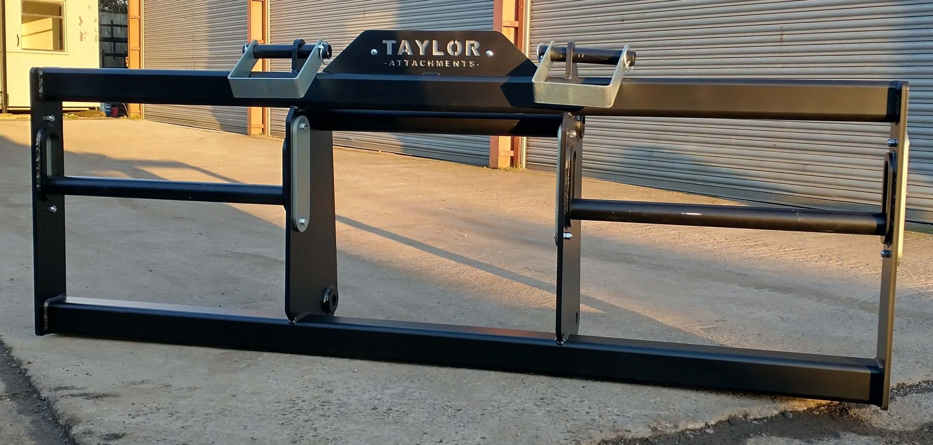 A taylor forklift attachment is sitting on the ground
