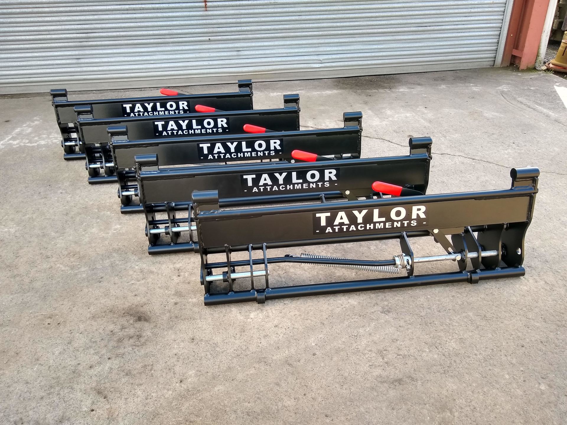 A row of taylor attachments are lined up on the ground