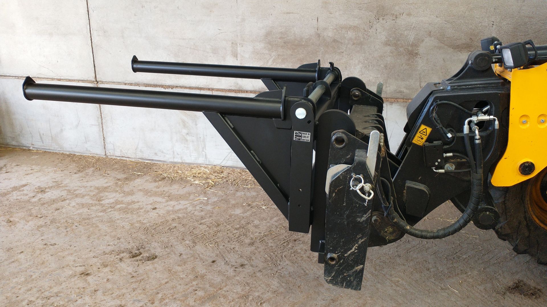 A black and yellow machine is sitting in front of a wall.