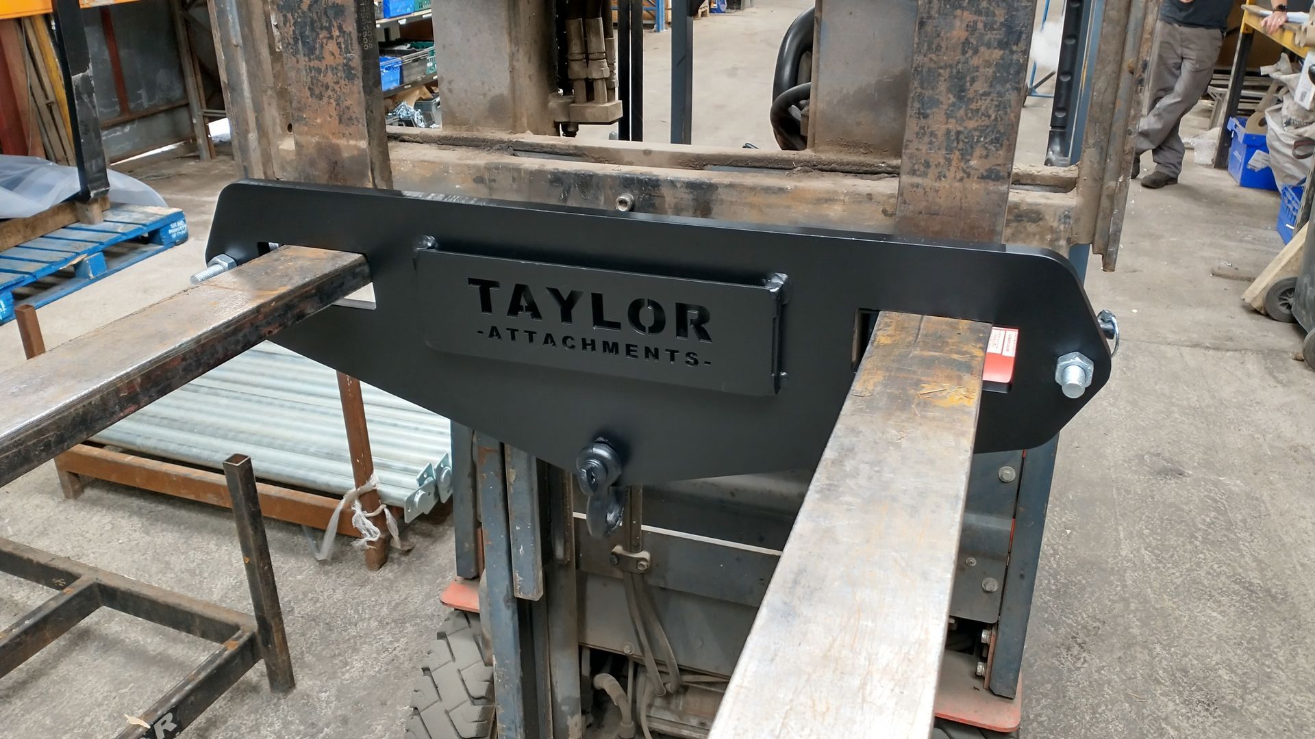 A forklift with a taylor attachment attached to it.
