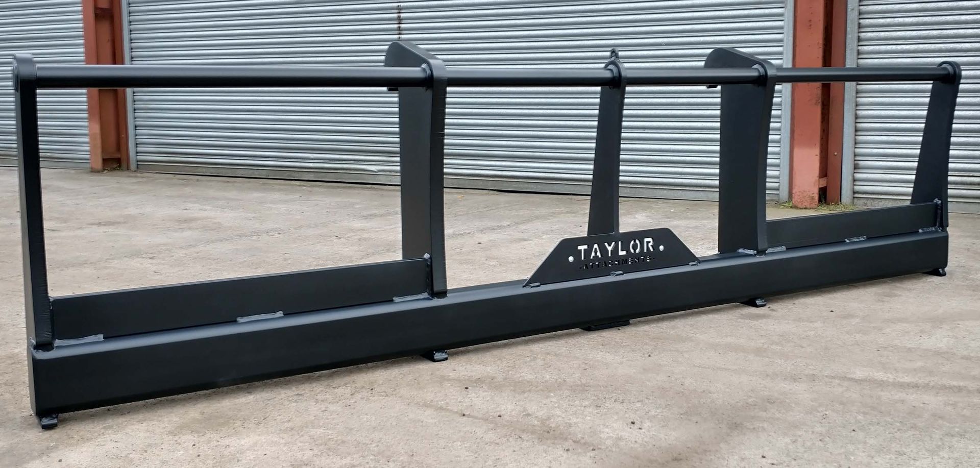 A black metal item with the word taylor on it