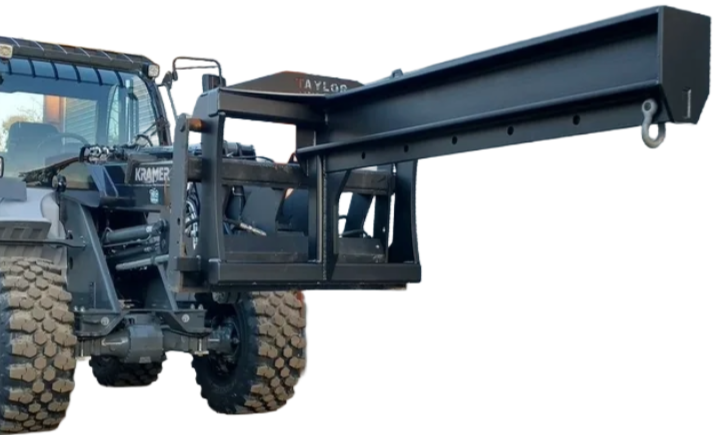 A tractor with a forklift attached to it is parked in front of a building.