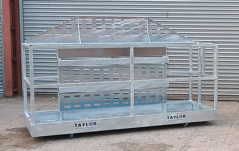 A black metal cage is sitting on the ground in front of a building.