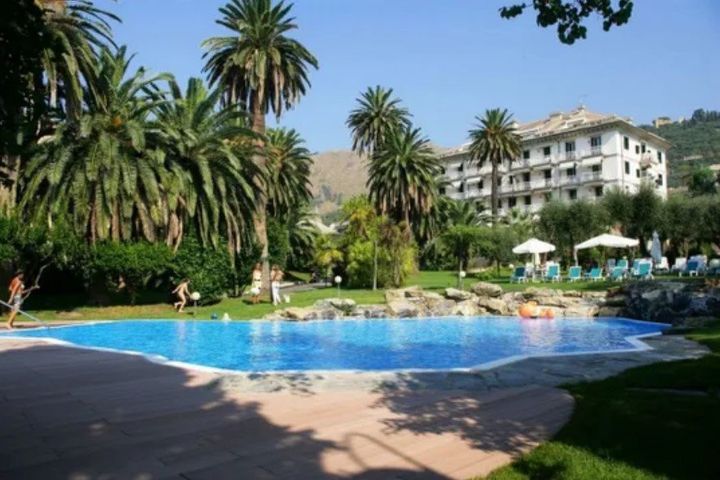 structure surrounded by greenery with swimming pool