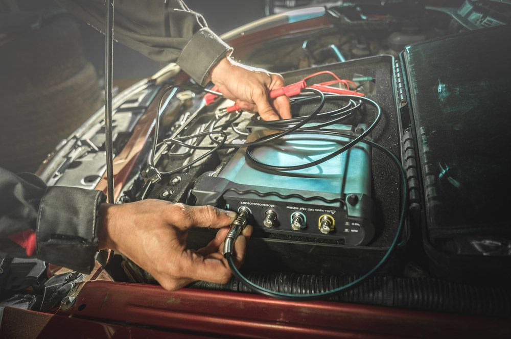 Expert Electrician Connects Oscilloscope to Engine — A-Lect Auto Electrical & Air Conditioning In Garbutt QLD