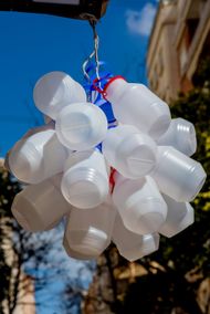 A bunch of plastic cups hanging from a rope