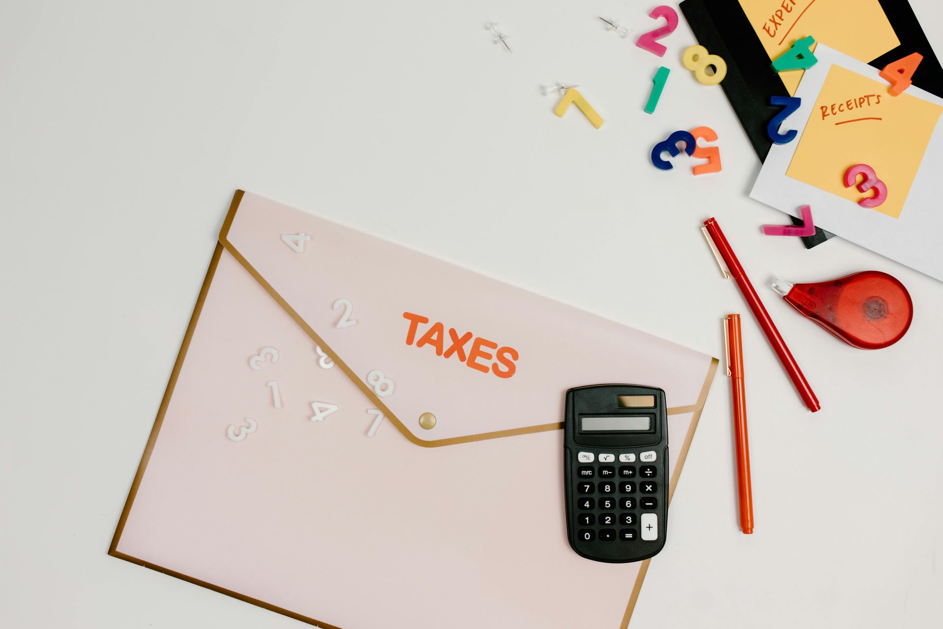 A pink envelope with the word taxes on it