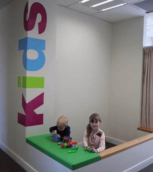 Kids playing at the kids desk in Collingwood Health clinic