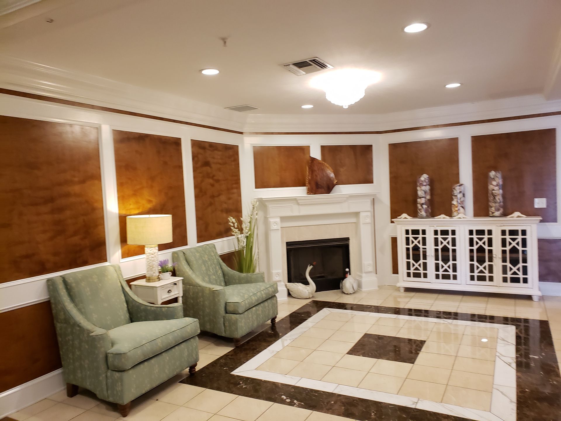 A living room with two chairs and a fireplace.