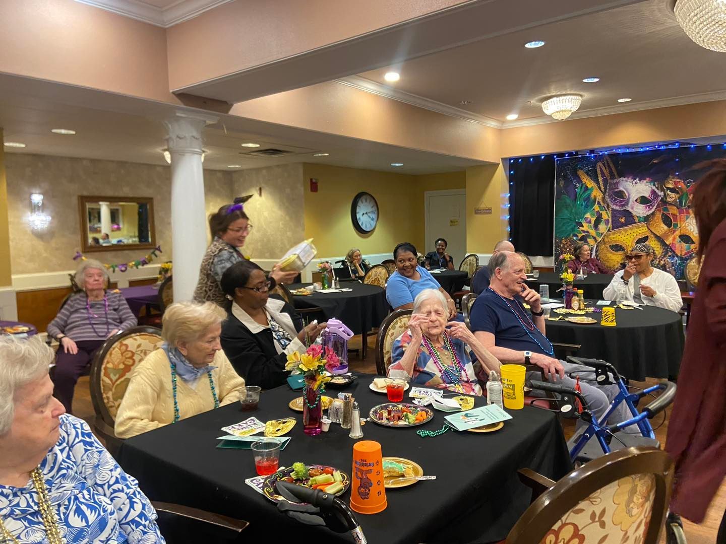 A group of people are sitting at tables in a room.
