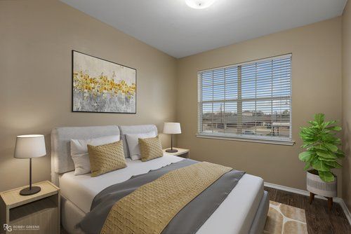 A bedroom with a large bed and a window.