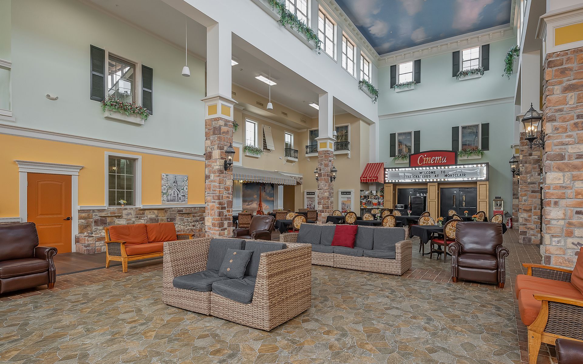 A large lobby of a hotel with lots of furniture and chairs.