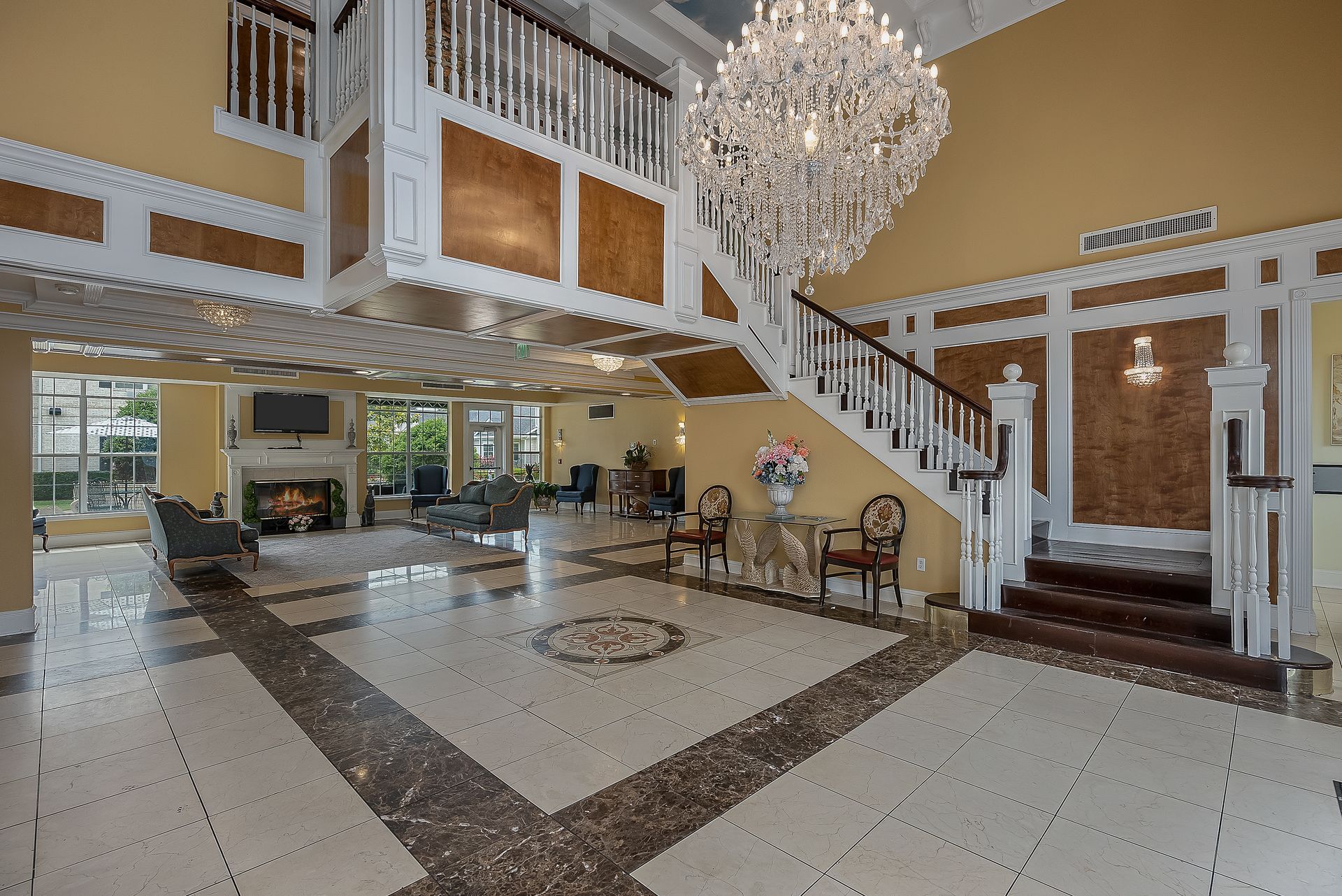 A large lobby with a chandelier hanging from the ceiling