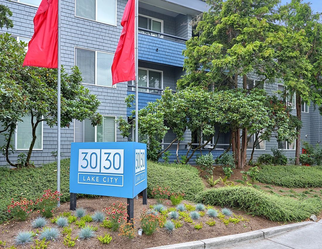 A blue apartment building sign labeled 