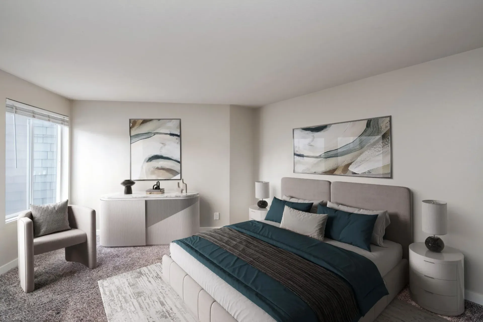 Modern bedroom with a gray upholstered bed, teal bedding, an accent chair, a dresser, and two abstract wall paintings.