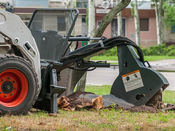 Stump Grinding — Machine Removing Tree Stump in Broken Arrow, OK