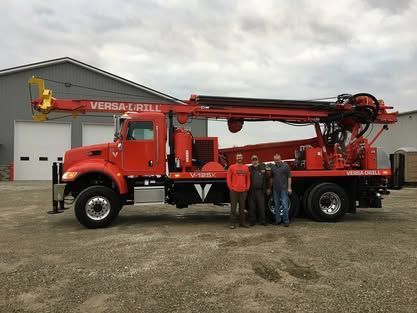 A Group Of Men Is Standing In Front Of A Red Truck - Union City, IN - Wiley Well Drilling