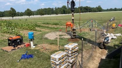 A Group Of People Is Working On A Construction Site In A Field - Union City, IN - Wiley Well Drilling