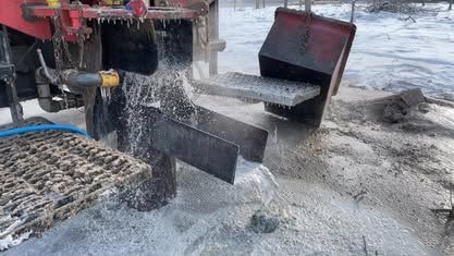 A tractor is drilling a hole in the ground in the snow - Union City, IN - Wiley Well Drilling