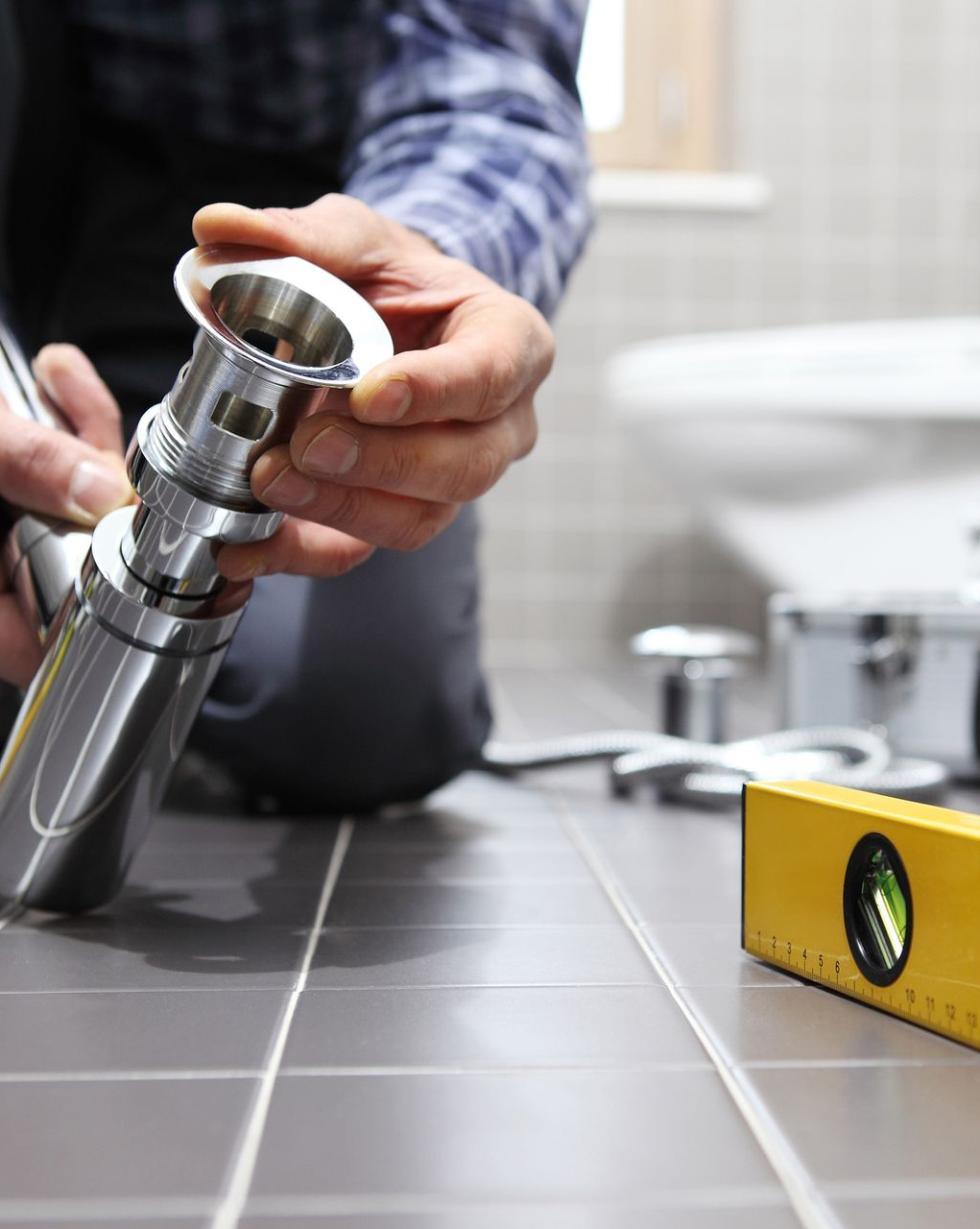 Expert plumber fitting faucets and fixtures as part of a complete bathroom remodel project. Expert plumber fitting faucets and fixtures as part of a complete bathroom remodel project.