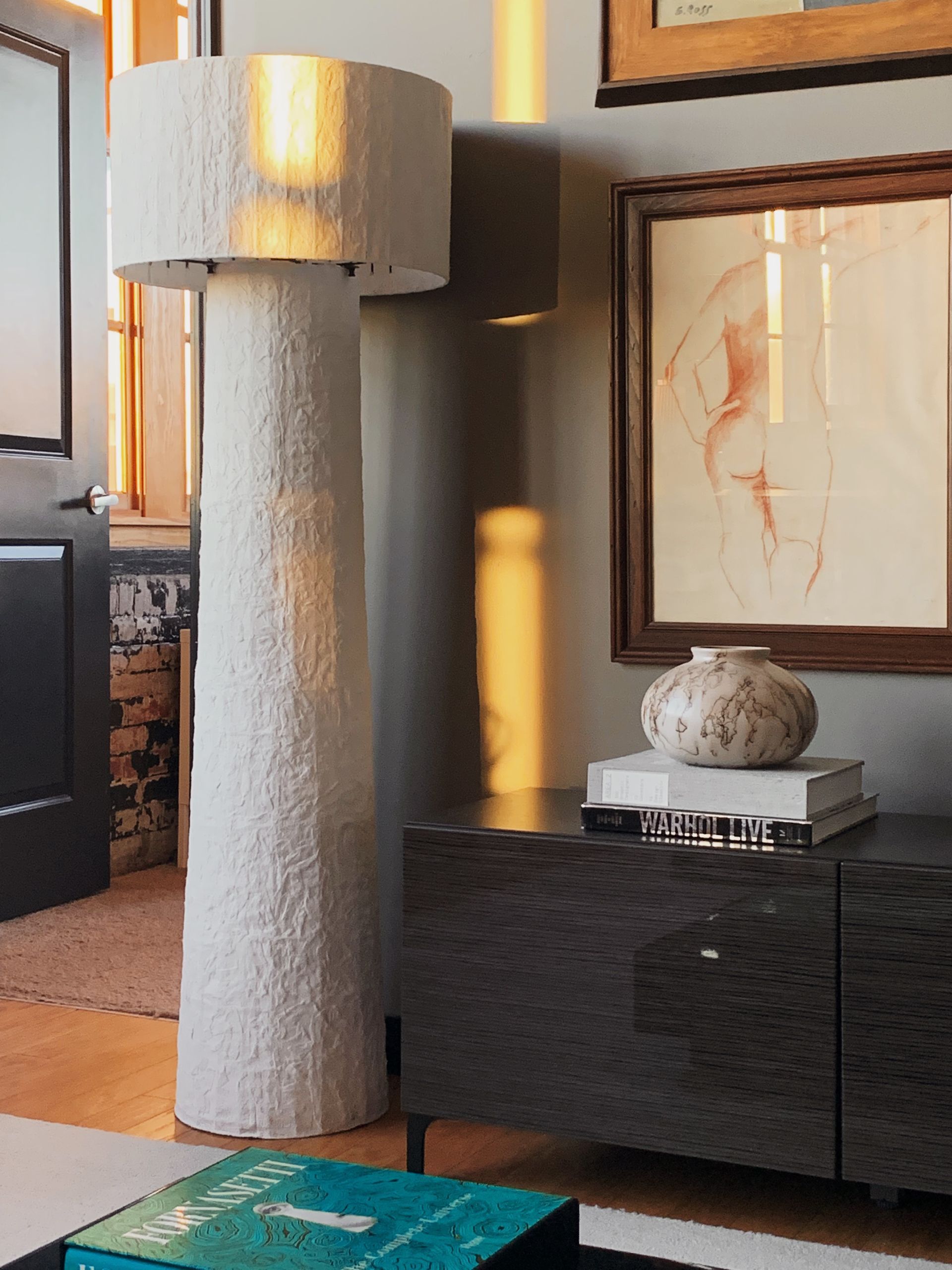 a plaster floor lamp with a raku vase and figure drawing