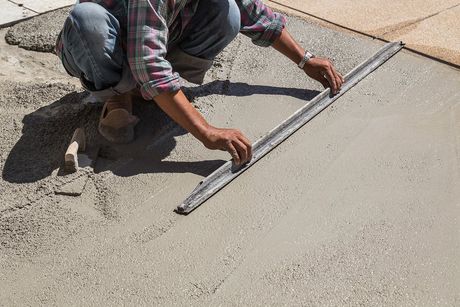 man flattens the cement