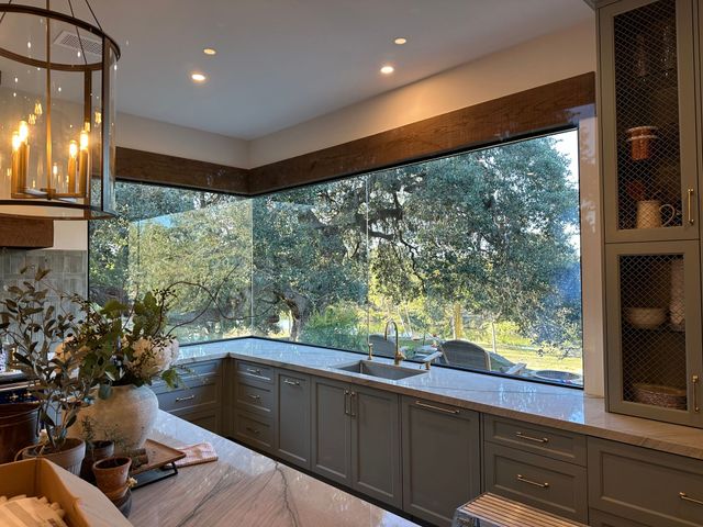 Gray sports car parked outside a building with the business name 