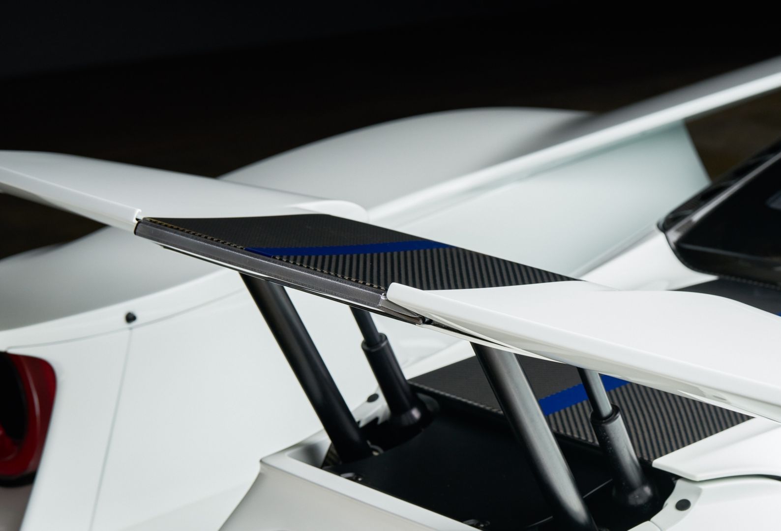 Black and white Polaris Slingshot three-wheeled vehicle, top-down view, parked indoors. Features 