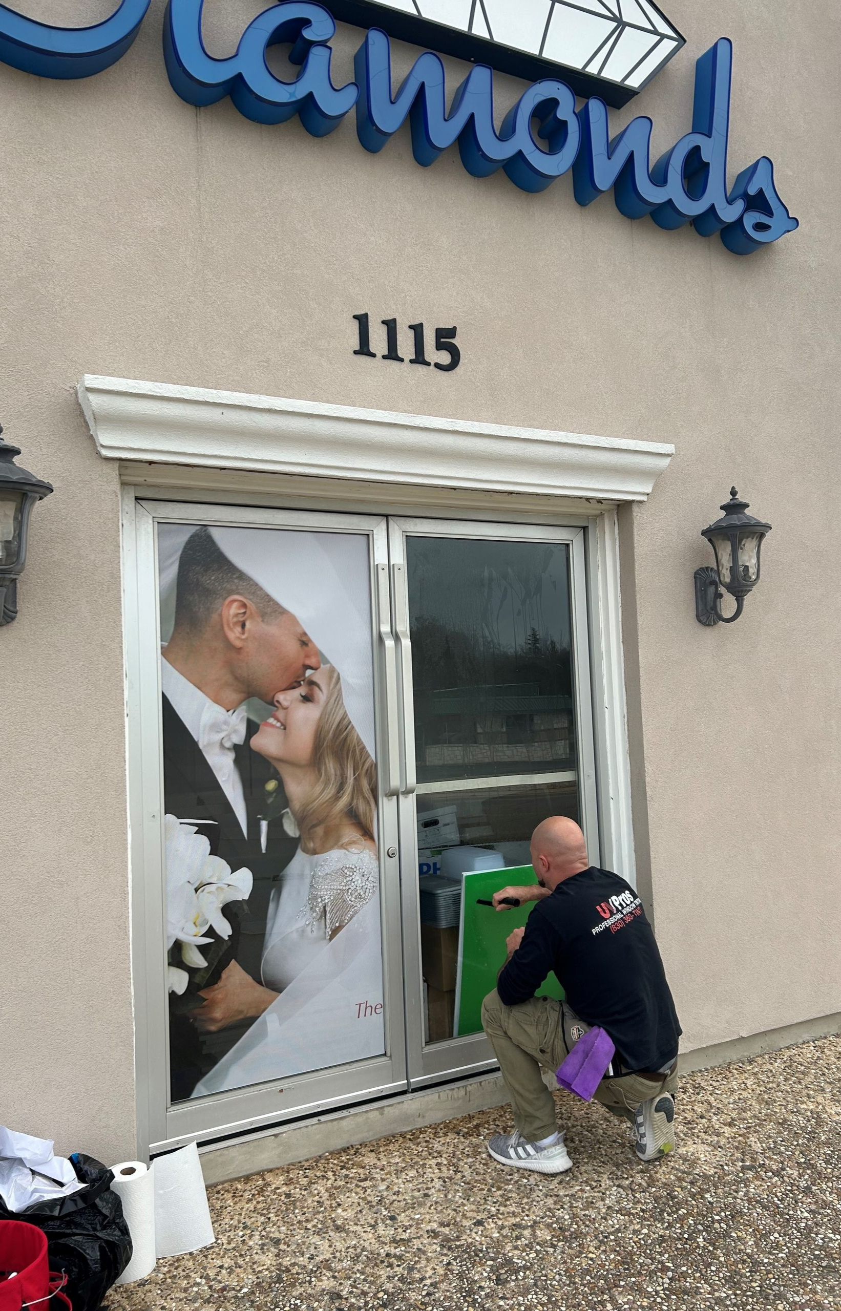 Elegant interior with large windows, stone walls, and modern light fixtures. Furnished with chairs and tables in a bright, open space.