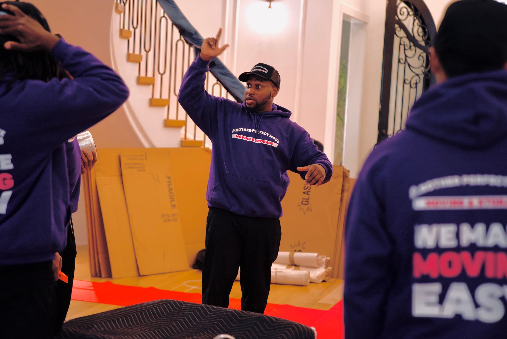 A man wearing a purple hoodie that says we make moving easy